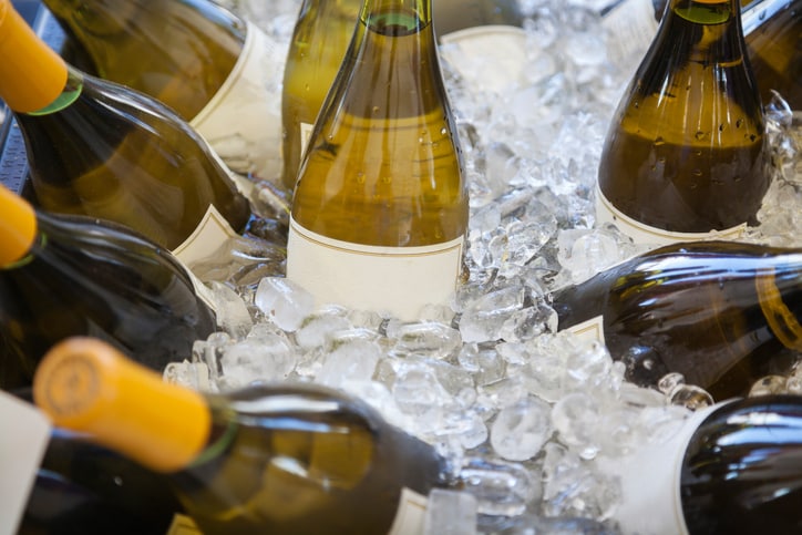 Bottles of white wine in ice bucket