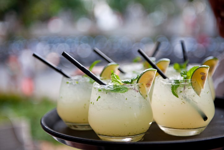 Waiter carrying mojitos on tray