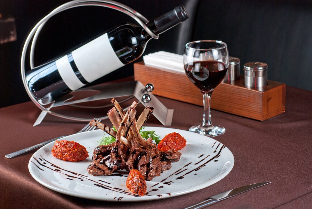 Roasted lamb chops with vegetables on decorated table